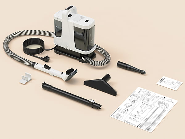 White handheld vacuum cleaner with attachments on a beige background